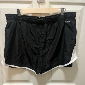 2 pairs of running shorts. Black and white. Green and white.